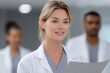© Dzikrul Husnani - Smiling Woman Doctor Holding Paper with Colleagues in Background