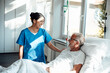© Westend61 - Nurse providing care and support to a patient in a hospital room