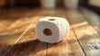 © Tania - Toilet paper roll on wooden floor with soft ambient lighting