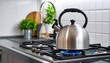 © Innovative - metal silver modern kettle in kitchen