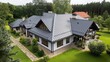 © Smaev - Metal roofing sheets are being installed by a roofer on a residential property
