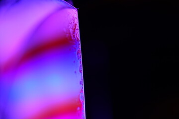 Poster - Pink  minimalistic liquid surface on black background, oil stains movement, bright chemistry, surreal background, deep galaxy atmosphere