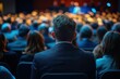© kong - Audience attending an event or conference with a focus on the back of a man in a suit surrounded by others in formal attire, creating an attentive and professional atmosphere