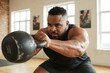 © PrettyStock - Strong African American Man Doing Kettlebell Exercise in Gym for Fitness and Strength