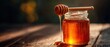 © Aether Pixels - Honey dripping from dipper into jar on wooden table in warm light close up sweet treat natural food ingredient healthy lifestyle