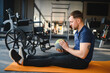 © Serhii - Man in wheelchair engaging in gym rehabilitation