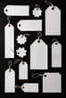 © bao - A variety of blank white tags with strings arranged on a black background
