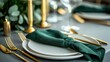 © Roun Sreylak - Sophisticated holiday dinner setup with white plates, golden cutlery, and green napkins placed on a modern concrete surface.