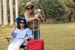 © Pix4Ads - Indian senior traveler couple holding a red suitcase and passport with a flight ticket at outdoor