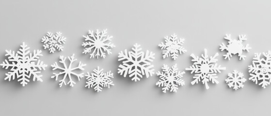 Poster - Winter Snowflakes Arranged on Light Gray Background Flat Lay Still Life Overhead View for Holiday Season Decoration and Design