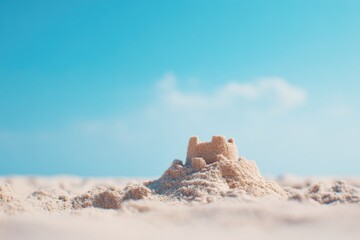 Poster - serene beach scene with untouched sandcastle under clear sky