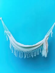 Poster - Empty white hammock hanging against a bright blue wall in studio shot for relaxation and vacation themed imagery