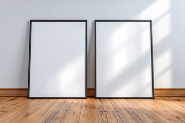 Poster - Two blank picture frames stand against a white wall on a wooden floor, illuminated by soft natural light streaming from a window, creating a serene atmosphere for design.