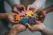 © whitestorm - Diverse hands holding colorful puzzle pieces together, representing unity, teamwork, problem-solving, and connection to achieve common goals and objectives.
