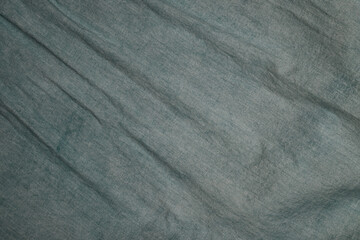 Leinwandbilder - Textured fabric surface with subtle folds and creases in a blue-green hue suitable for various artistic applications