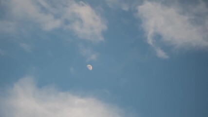 Aufkleber - Moving white clouds on blue sky with the moon time lapse, mystical mood concept