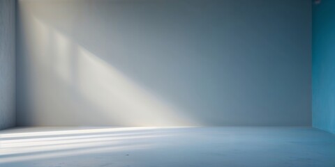Poster - Bright sunlight streams into a minimalistic room with one blue wall and white floors, creating a calming atmosphere