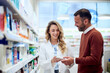 © bnenin - Pharmacist Assisting Customer in a Pharmacy with Friendly and Professional Interaction