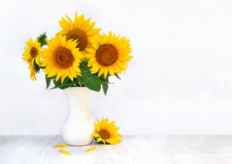 Wall Mural - bouquet of yellow flowers sunflower in porcelain vase on a white wooden table on light background wi