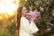 © New Africa - Beautiful woman with lilac flowers outdoors in morning