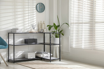 Poster - Console table with different decor near white wall indoors. Interior design