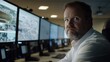 © Mary - A security officer attentively watches numerous CCTV monitors displaying critical live feeds in a dark operations room, creating an atmosphere of vigilance and focus