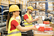 © Dejan - Warehouse workers are focused on organizing boxes, emphasizing teamwork and the importance of efficient logistics.
