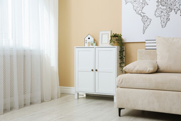 Poster - Dresser with stylish decor and houseplant near beige wall in room