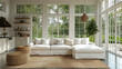 © sommersby - Cozy modern living room interior with white sofa, natural rug, wicker stools and large windows overlooking greenery