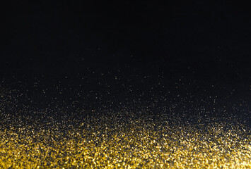 Poster - Golden glitter sand texture border on black, abstract background with copy space. Yellow dusty shimmer decoration, shiny and sparkling. Holidays and glamour concept.