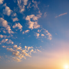 Wall Mural - sunset with bright sun, blue sky and pink clouds