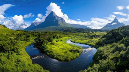 Aufkleber - Majestic mountain peak towering above lush green valley with a winding river, clear crisp air and blue sky