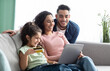 © Prostock-studio - Happy Arabic Family Using Digital Tablet And Credit Card For Online Shopping, Relaxing On Couch At Home, Young Parents And Their Little Daughter Making Purchases From Internet Together, Free Space