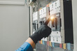 © Nonthanat - Electrical equipment maintenance service engineer Engineers carry AC voltmeters to check voltage at breaker terminals and inspect switchgear.