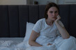 © New Africa - Frustrated young woman suffering from insomnia on bed indoors