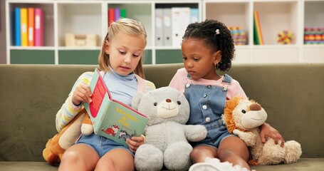 Poster - Girls, reading or sofa with book for story time, education or learning together at elementary school. Children, kids or students with novel on couch for childhood development, fiction or imagination