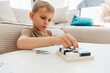 © Elena - Focused Child Solving Puzzle at Home