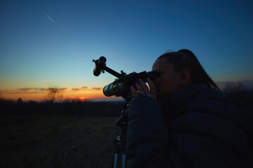Wall Mural - amateur astronomer using telescope for watching stars, moon, planets and other celestial objects fro