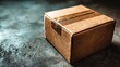 © huiying - Cardboard box placed on warehouse table under soft overhead lighting viewed from 45-degree angle with minimal background, storage and packaging concept in industrial environment for shipping and logis