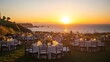 © hidayati - An outdoor wedding reception on a cliff overlooking the ocean sunset