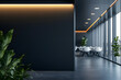 © Prasanth - Blank dark wall mockup in modern office interior with blurred meeting room and white chairs in background with copyspace for branding or signage.