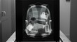 © Adobe - X-ray image shows backpack contents clothes, bottle, and other personal items