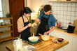 © Prathankarnpap - Happy couple preparing homemade pancakes in a warm kitchen