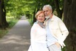 © New Africa - Lovely senior couple together in park, space for text