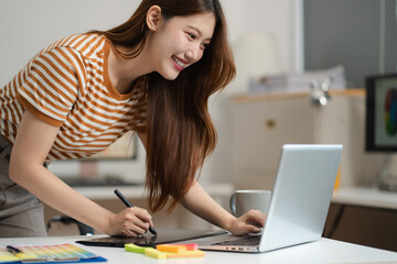 Designer woman thinking ideas strategy about mobile app interface wireframe design with customer breif and color code, User experience concept.