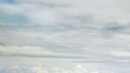 Wall Mural - blue sky with white fluffy clouds from airplane flight fly over the clouds in a sunny day with cloud moving in the atmosphere in hot weather summer time. summer cloudscape natural background