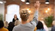 © Sergey - Student raising hand during a lecture in a modern loft-style university room with exposed brick