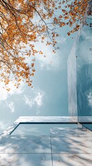 Poster - Marble architectural facade reflecting golden autumn foliage under bright sunlight