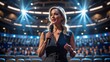 © rosen thal - Confident woman giving a speech on a stage in front of a large audience