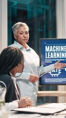 Poster - Mature woman, presentation and machine learning at office, screen and discussion for AI development. Person, speaker and monitor for futuristic tech, meeting and review for project at startup agency